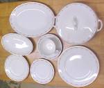 This is a nice set of china dishes with a nice floral (rose and leaf) design ring around the near edge of each plate, cup, saucer, and the same with the serving dishes that are included. All are the s...