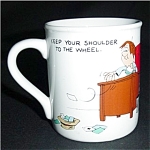 This is a Hallmark Coffee Mug. It says "Keep your shoulder to the wheel" and "Keep your nose to the grindstone. It measures 3.5" tall and is in good condition. No chips or nicks.