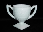 This is a two handled Indiana Glass Milk Glass Sugar Bowl. It measures at 4" tall and 5 1/4" in diameter. It is in good condition.