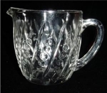 This is an Anchor Hocking Crystal "Beaded and Bar" 20 ounce Milk Pitcher. It measures 4 1/2" tall and 4 3/4 in diameter.