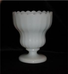 This Footed Milk Glass Compote has a scallopped rim. It measures 5 1/2" tall x 4 1/2 in diameter. Good condition, no chips or nicks.