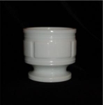 This is a Milk Glass Planter. It measures at 4 1/4" tall and 4 1/2" in diameter. It is in good condition.