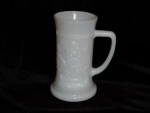 This is a Federal Milk Glass Stein. The scene on the stein shows two people sitting at a table and another serving them ale. Good condition, no chips or nicks. Has the Federal trademark on the bottom....