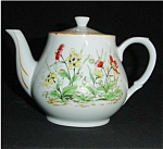 This is a Floral Teapot Made in Japan. It measures 5.5" tall and is in good condition, no chips or nicks.