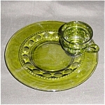 This is a Green Thumbprint Indiana Glass Cup and Tray Set. The plate is 10.25" in diameter. The cup measures 2.5" tall and is 3.5" in diameter. Good condition, no chips or nicks.