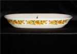 This is a divided casserole server. It is made by Capri in Japan. It measures 13" x 7 1/2". Good condition. No chips or nicks.