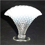 This is a Fenton Hobnail Opalescent Mini Fan Vase. It measures 4" tall and is 4.5" long by 1.25" wide. Excellent condition, no chips or nicks.