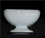 This is a Milk Glass Footed Candy Dish with a acorn and vine pattern. It measures at 3 1/4" tal and 5 1/2" in diameter, and is in good condition.
