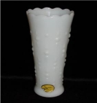 This is a Simpson's Carousal Milk Glass Vase with ruffled edges, and has paper label. It measures 7" tall and is in good condition.