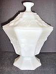 Anchor Hocking Milk Glass Footed Panel Candy Dish.Dish,Cover,and Base are all in seven panal shape. Has grape and leaf design,and stands 8 ins. tall. Marked with an anchor.Is in very good condition. P...