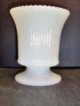 E.O.Brody Milk Glass Pedestal Vase in a Ribbed Design.This is a translucent milk glass vase in a oval shape. Vase stands 5in. tall with a scalloped rim 4-1/4in. wide.Vase is 3-1/2in. deep. Marked on t...