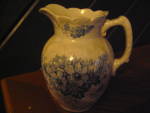 Vintage Blue Flowered Milk/Cream/Syrup Pitcher,cream white with blue flowers and leaves.Pitcher is 6 1/2" tall and 5 1/2" wide.Good condition,very nice vintage pitcher.Unmarked.