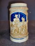 Vintage German Like Stein Made in Japan. 2 women watching a man on the front, flowers on the other. 5.5" high by 4" across including handle. Very Good color.  Marked on the bottom K inside a...
