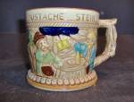 Vintage Apex Japan German Like Mustache Stein Made in Japan. 3.5" tall by 5" across including handle. The front has a 2 men giving a  toast, deer on the other. Very good color. Very good con...