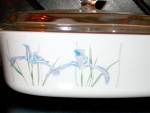 Vintage Corning Ware Covered Casserole Shadow Iris, milk glass white with pastel Iris design. Comes with clear glass cover.A-2-B, 2 liter size, Casserole in very good condition.