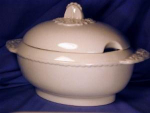 Small ivory tureen. Stoneware. England or U.S.A.  c. 19th century.  Simple charm. Relief molded finial, handles & connecting ruffle between handles are the only decoration needed. Measures approximate...