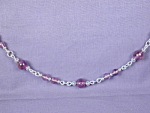 Amethyst & SS Link necklace.  Round Amethyst beads of 6 & 4 mm along with Sterling Silver round beads of 2 & 3 mm (all on Sterling Silver wire) form the links of this approximately 26 inch long neckla...