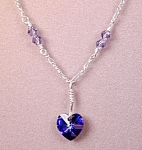 Swarovski Heliotrope Heart & SS Necklace. A fine Sterling Silver Figaro chain is supplemented by twelve 4mm Swarovski Tanzanite bicone crystals on links of SS wire with wrapped loops. The 10mm Swarovs...