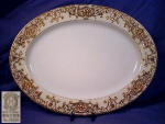 Noritake Platter w/hand painted gilt border. Porcelain. Japan.  c. 1911+.   Simple & elegant. Relief molded border design of stylized flowers hand painted in gilt on a pale ivory ground.  Raised beads...