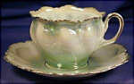 Porcelain. Germany. Unmarked, attributed to R.S. Prussia.  c. 1900s.  Very high luster pale green body with a deeper shade of the green at the top & bottom of the cup. Gilt edged & gilt sponged,  gilt...