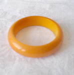 Butter Yellow Bakelite Bangle Bracelet. Polished Shiny exterior finish which has a 2 1/2 inch Interior opening and measures 3 3/8 inches straight across outside edge to outside edge.The inside is a Sa...
