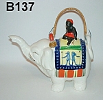 This truly remarkable Black Native on an Elephant Teapot is 7 1/2" high.  Marked on the bottom, "Hand Painted, Japan".  Gold trimmed.  Original bamboo handle.  Circa: 1940's.  This...