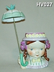 This very unusual Little Umbrella Girl Head Vase is 5" tall (8" tall with umbrella) and is all original. It is very difficult to find with the original umbrella! A It is marked on the bottom...