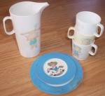 Set of plastic dishes made by Chilton Toys of  Manitowoc Wisconsin. It has a little western<BR>dressed rag doll on the fronts of the cups and pitcher. The plates have the cowboy on them. Not<BR>sure w...