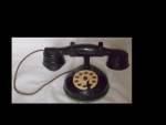 Great old toy telephone made of black metal. The bottom ius covered in a green felt by someone. It is NOT glued on just added using the screws that hold it together. You can feel the 4 tiny feet. Look...