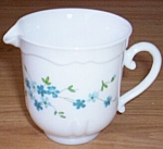 Lovely little creamer made in France by Arcopal. Done in a milk white with tiny blue flowers on<BR>both sides. Excellent condition. Stands 3 1/8" tall by 4 1/2" wide.<BR>