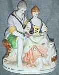 Featured for your enjoyment is a wonderful old porcelain figurine of a courting couple. He is<BR>handing her a lovely red rose, which is in excellent condition, in his outstretched hand.  He has<BR>hi...