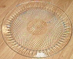 Featured for your enjoyment is this lovely old serving platter or cake plate. It has a twisted<BR>diamond pattern. The diamonds have a swirl affect to them. They are impressed from the bottom.<BR>The ...