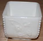 Done in milk glass this square puff box base is from Westmoreland Glass in their Beaded Grape pattern. It is the bottom only but is in excellent condition. It stands 3 " tall by 3 " square...