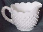 Old Fenton hobnail oval creamer from 1948 in their milk glass. It is in excellent condition. Stands 4" tall by 6" from spout to handle and 3 " wide. It has the old pointed hobnails.