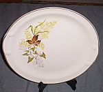 Nice old plate, could be for serving or a cake plate with the side handles. Has an autumn leaf<BR>pattern with golden rod. Excellent condition. Measures 10 3/4" across.<BR>