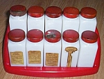 A set of 10 milk glass spice jar in their original red plastic spice rack. Some have labels still<BR>attached. One lid is rusted on the threads. This is a great set from the 50s.<BR>
