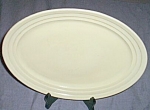 Hazel Atlas serving platter in their Moderntone pattern from the early 50s. Done in the pastel<BR>yellow. Some flea bites around the rim. Measures 12" by 9 1/2".<BR>