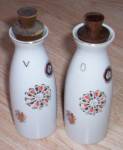 Great old porcelain vinegar and oil set here. It is marked with what appears to be a log with a wing over it and W.W. on the log. Also Japan and 22W. Although they look like a stoneware they are a ver...