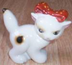This very playful looking kitten is hand painted with calico spots and a red polka dotted bow. It has a rub on the spot on the back and one on the tip of its tail. Just a color rub. Marked Made in oc...