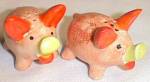 Cute pig shakers made in Occupied Japan. Done in an light orange body and darker ears. They<BR>have little yellow snouts. Both have the original cork stoppers. They stand 1 3/4" tall.<BR>