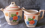 Featured for your enjoyment is a stunning cream and sugar set. This has a hand painted pattern of<BR>flowers. The criss cross pattern gives it a quilted affect. It has a squared off shape. Both pieces...