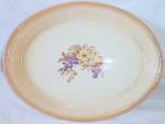 Large platter by Homer Laughlin in their 30's Oven Ware pattern with a fruit and floral transfer. Does show wear to the orangeish rim. Stands 1 1/2" tall by 13 1/4" long and 10 1/2" wid...