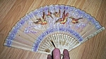 Featured for your enjoyment is a stunning old oriental fan. This has a lovely purple<BR>background. 5 small hand painted birds fly about the center. lots of gold highlight these little yellow, brown a...