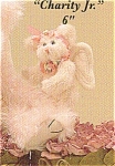 is a jointed 6 inch tall very light pink colored angel bear with a pink stitched nose and mouth.  Charity Jr. has cream colored angel wings and paw pads and wears a pink ribbon with cream rosettes aro...