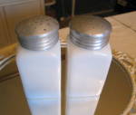 Vintage large milk glass jars. Both for one price. These are quite large and old. They stand 5 tall x 2 wide. The lids have some small dents as expected. No chips or cracks in the glass although one h...