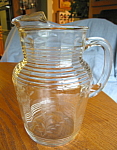 Nice looking, large etched depression glass pitcher. Frye Glass? Nice condition; has etched flowers and ribbed handle. It stands a bit over 9.5 tall. No chips or cracks. Looks like a polished pontil m...