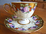 Beautiful Royal Sealy pedestal teacup featuring fruit, plums and a lot of gilt. Backstamped: Royal Sealy China, Japan. No chips or cracks; just a tad of wear off the gold on the saucer. Saucer is almo...