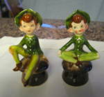 Vintage Enesco Japan Shakers. Peter pan? Cute salt & pepper shakers. Foil labels on bottoms. They once had cork shakers but those are missing. These stand 4 inches tall. No chips or cracks; some glaze...