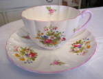 Vintage Shelley fine bone china teacup. c: 1945-1966. Very pretty feminine teacup. Pale pink scalloped rims with pink handle. Pink roses, daisies and other flowers. It has a 5 digit number on bottom a...