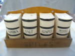 Vintage ceramic spice set. Bottom stamped: Japan. Cork stoppers; one stopper is missing. Very cute set; black stripes; wood rack. Flaws: there are some little rough spots/flea specks mainly along uppe...